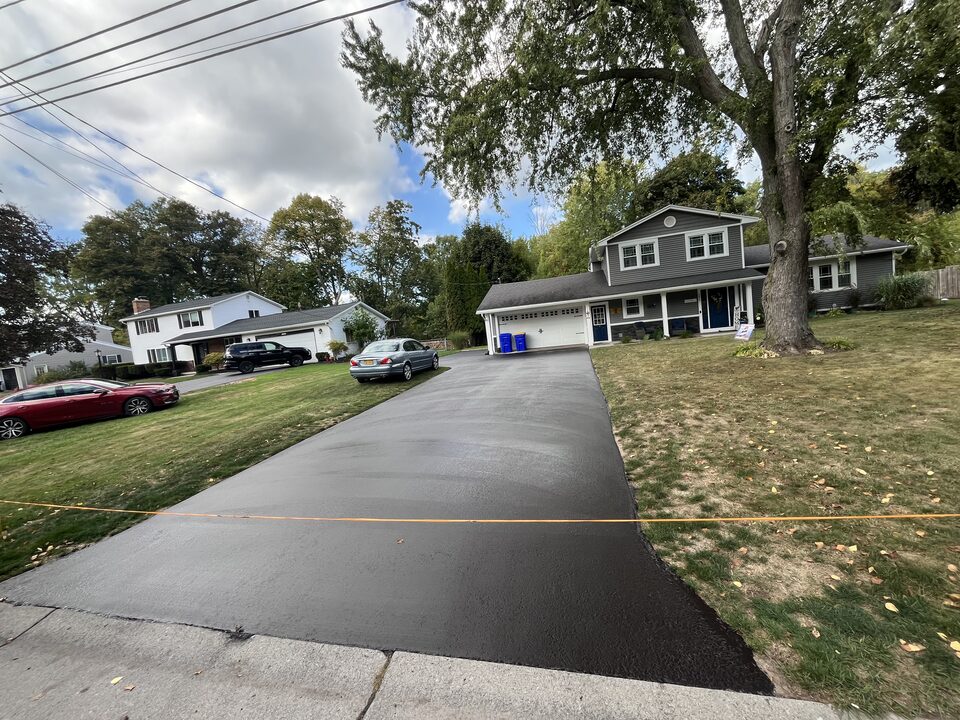 Freshly sealed residential driveway in Irondequoit, NY by Bold Seal